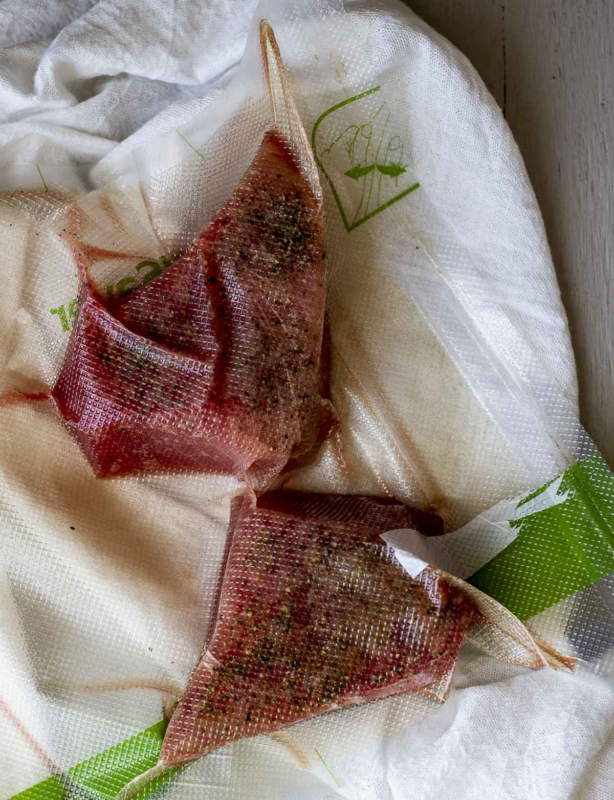 Two tuna steaks vacuum sealed in a bag.