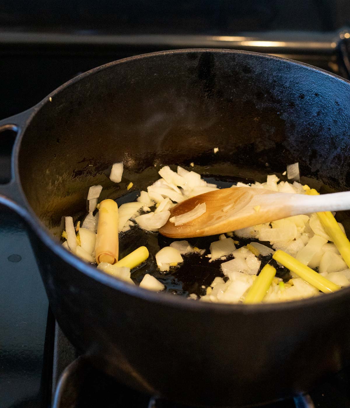 Onion, garlic, ginger and lemongrass being sautéed in a Dutch oven.