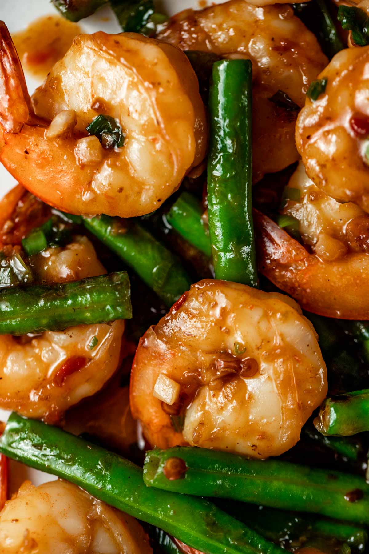 Close up view of spicy Hunan shrimp with green beans.