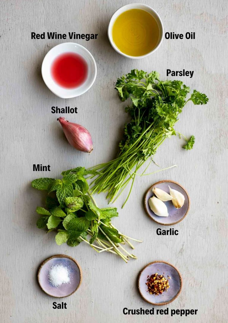 Ingredients to make mint chimichurri arranged individually and labelled.
