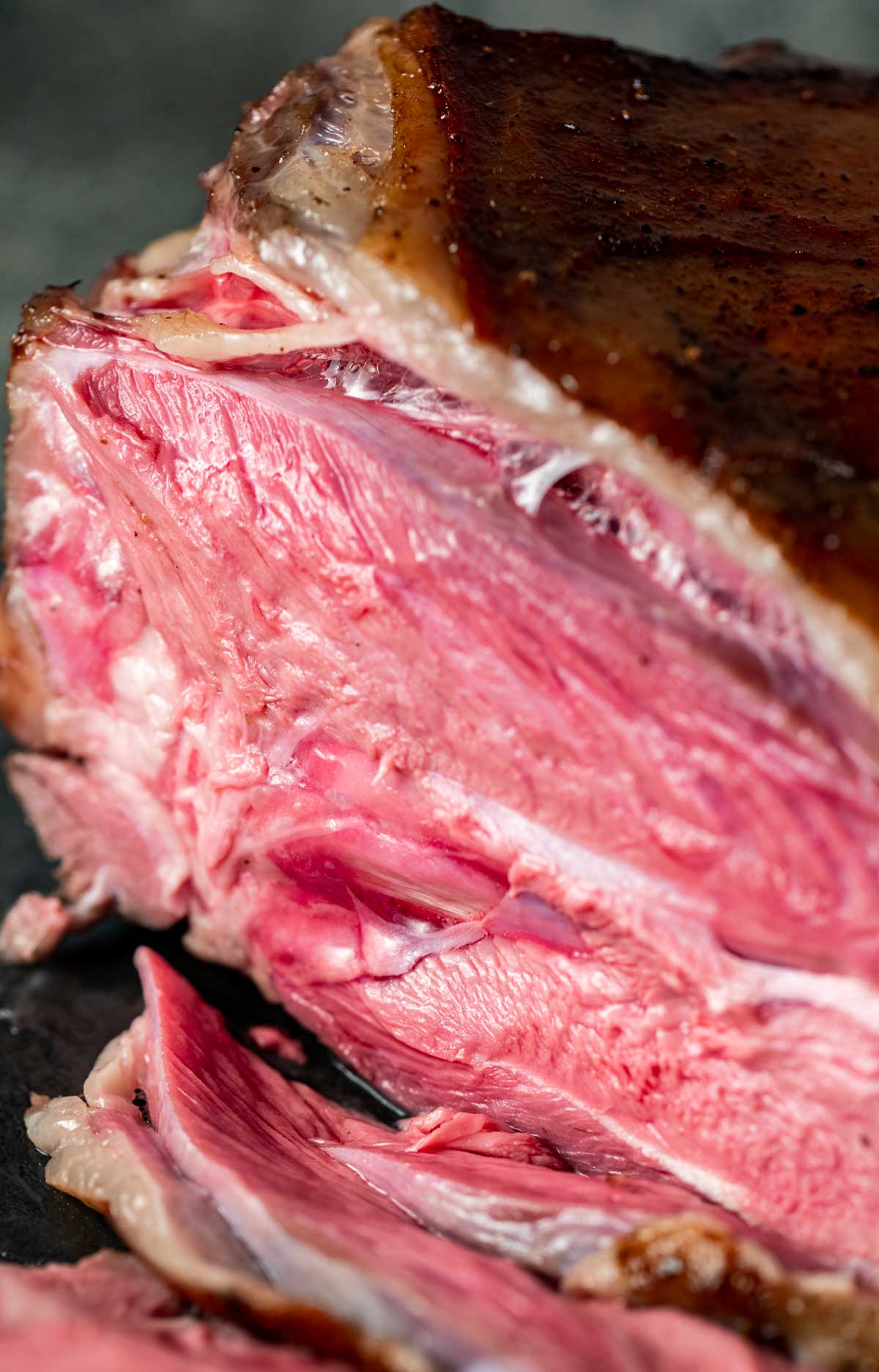 Close up view of the medium rare leg of lamb meat.