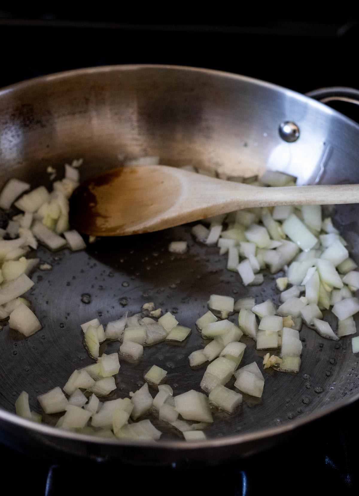 Onion, garlic and ginger sautéing in a skillet.