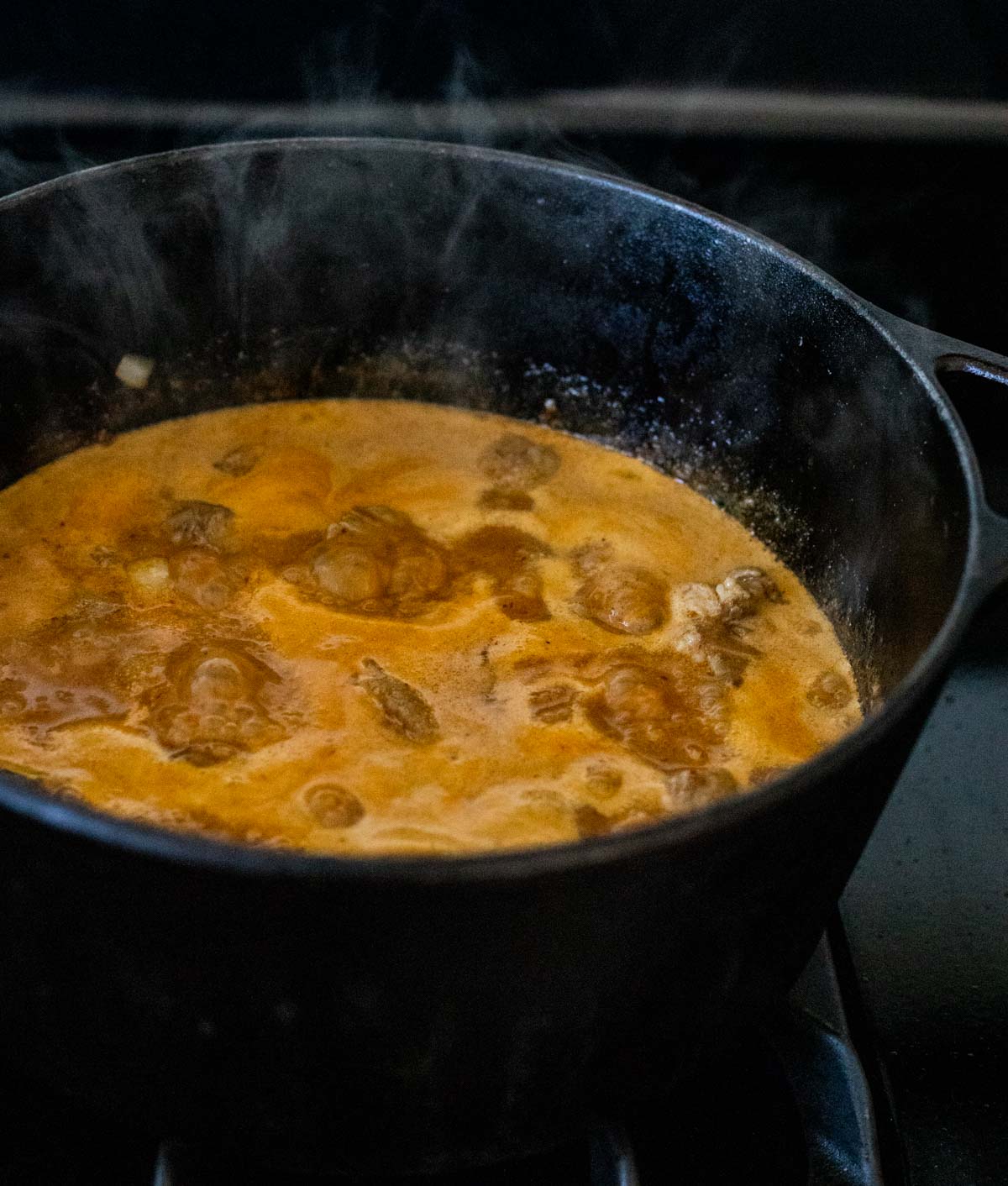 Massaman lamb curry simmering in a Dutch oven.