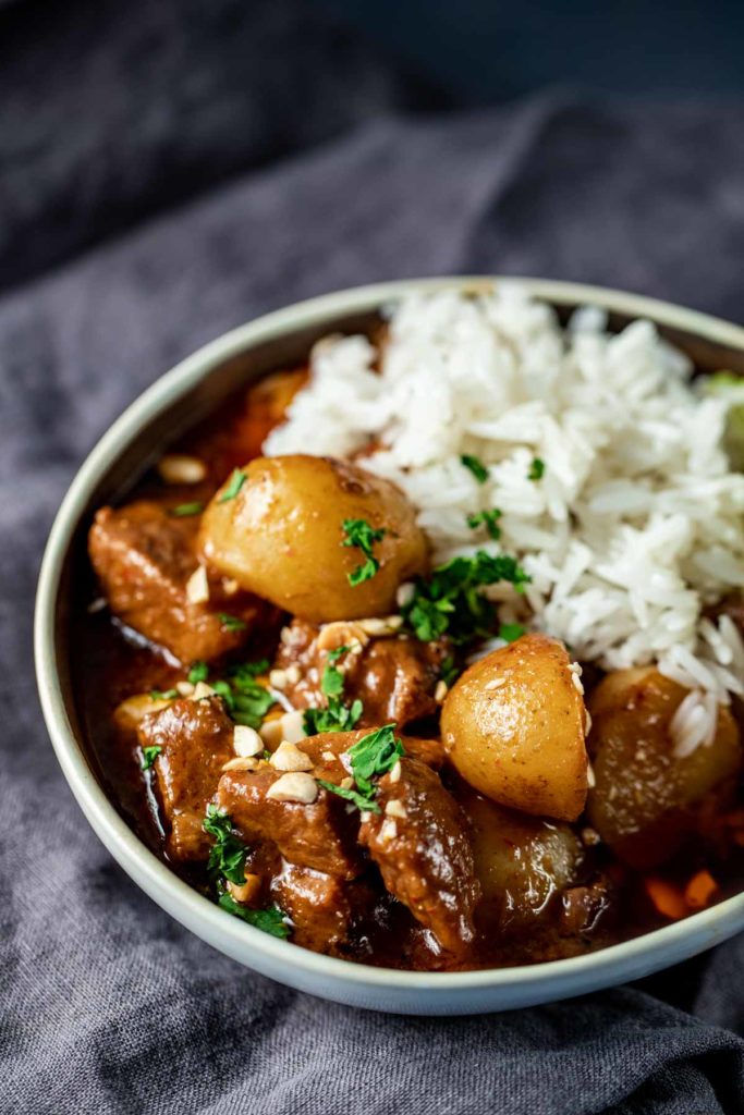 Massaman lamb curry in a bowl with rice.