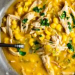 Close up view of corn and chicken soup in a bowl.