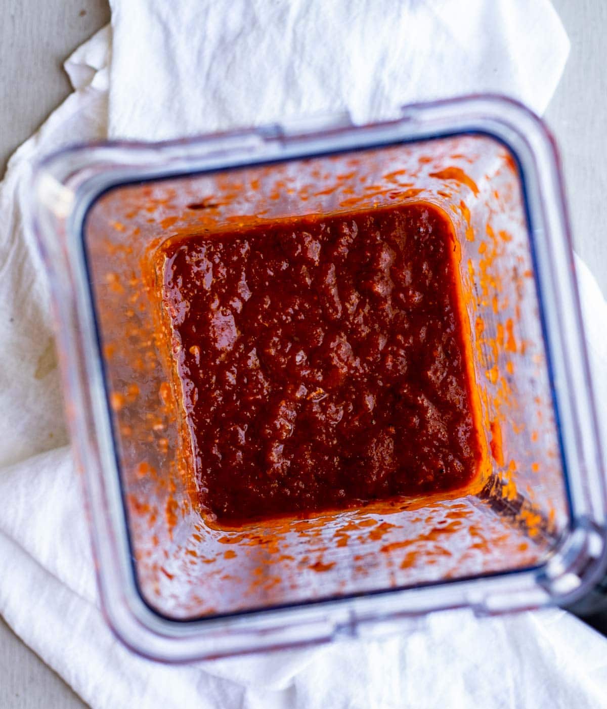 Overhead view of the red sauce blended together in the blender.