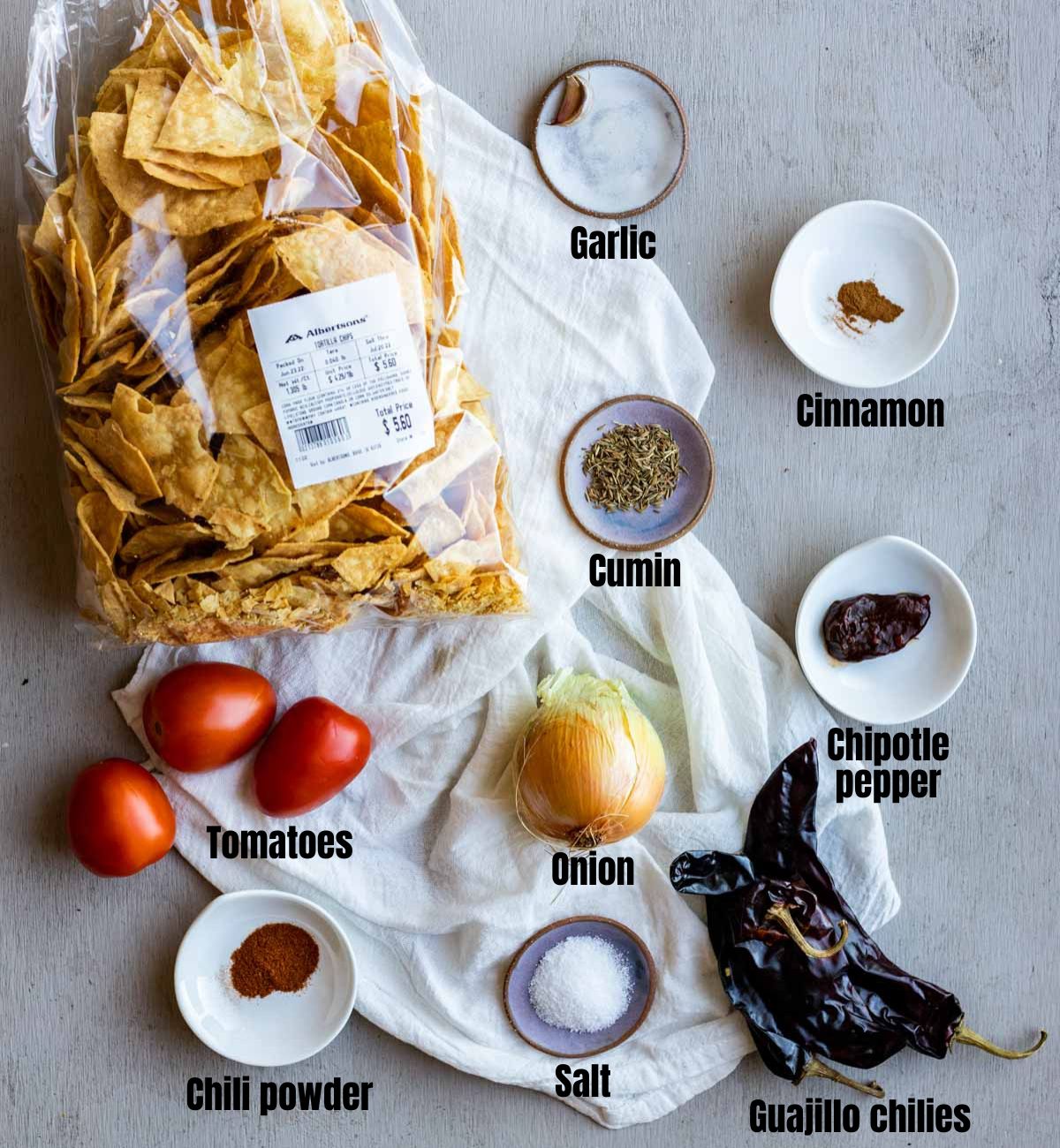 Ingredients to make chilaquiles rojos arranged individually and labelled.