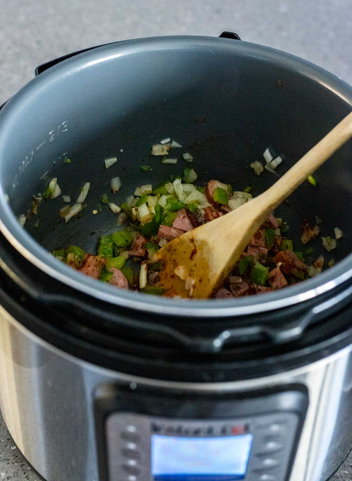 Vegetables and sausage pieces being sautéed in the Instant Pot.
