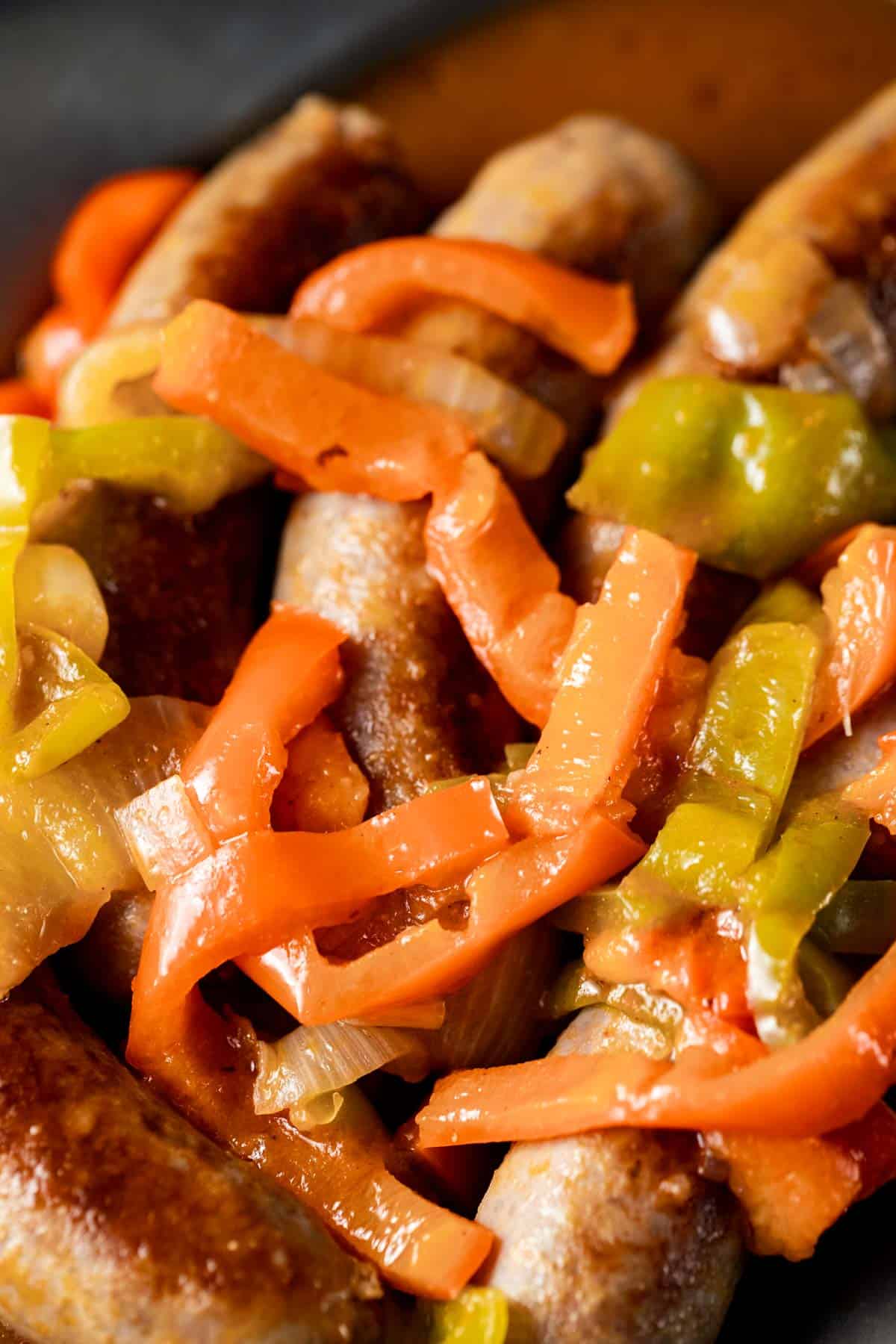 Close up view of peppers and onions on top of Instant Pot sausage.