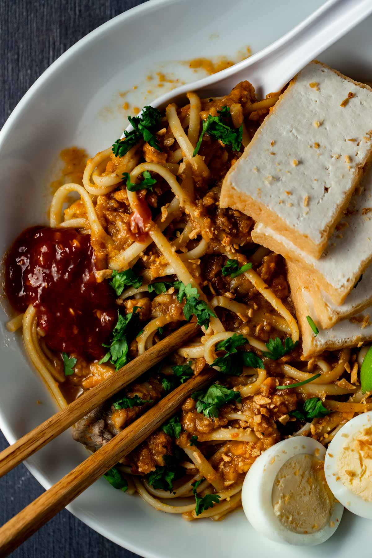 Overhead view of mee rebus in a bowl with chopsticks.