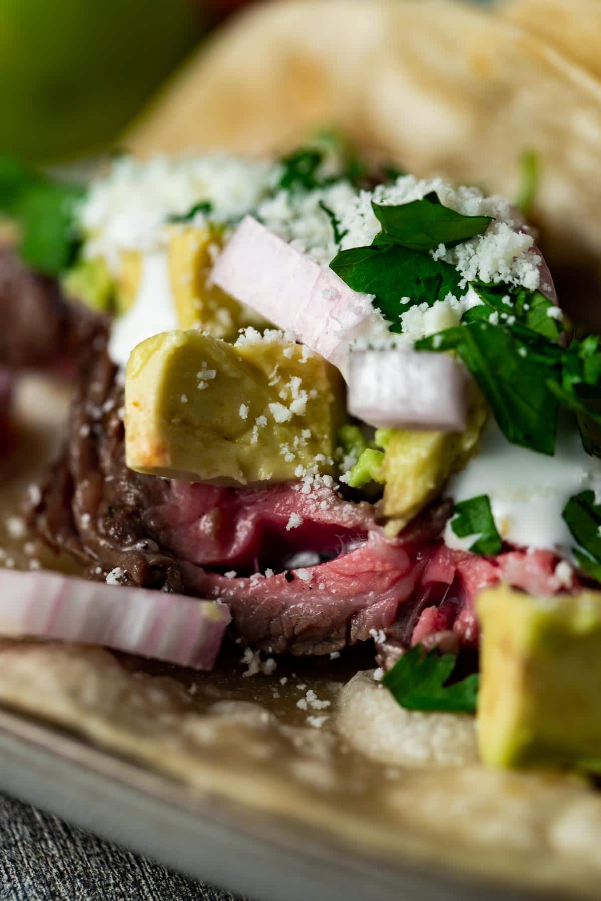 Close up view of carne asada and toppings.