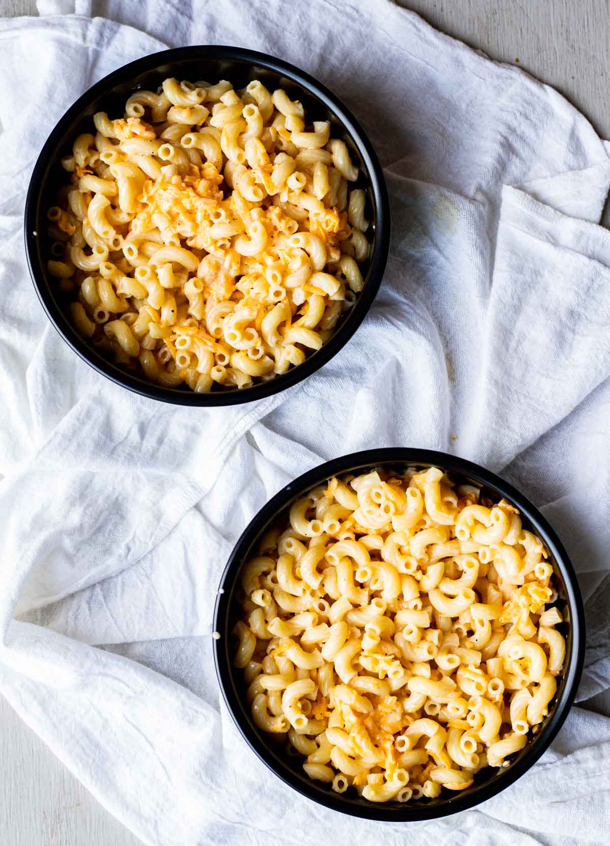 Mac and cheese mixture divided into two round pans.