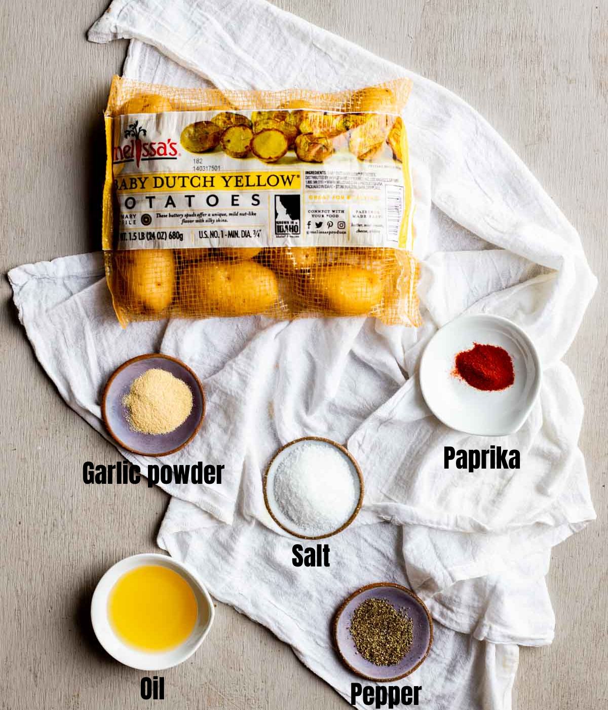 Ingredients to make air fryer baby potatoes arranged individually and labelled.