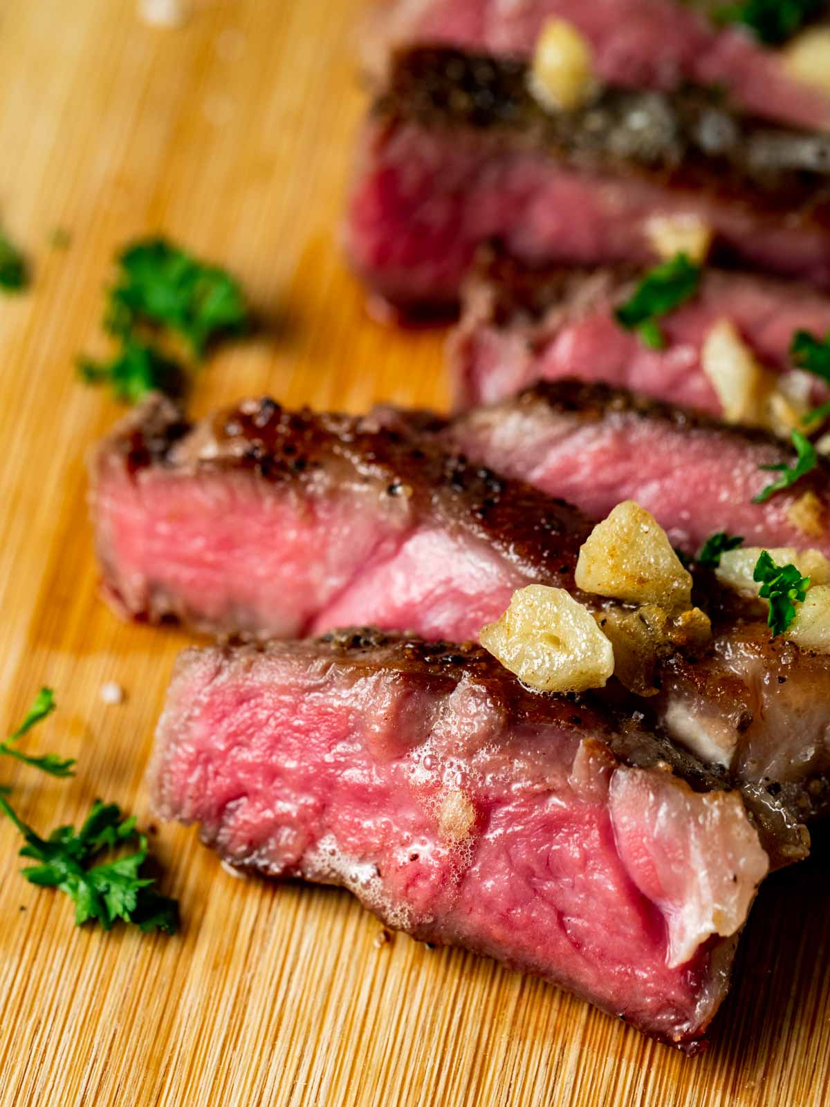 Close up view of slices of medium rare steak.