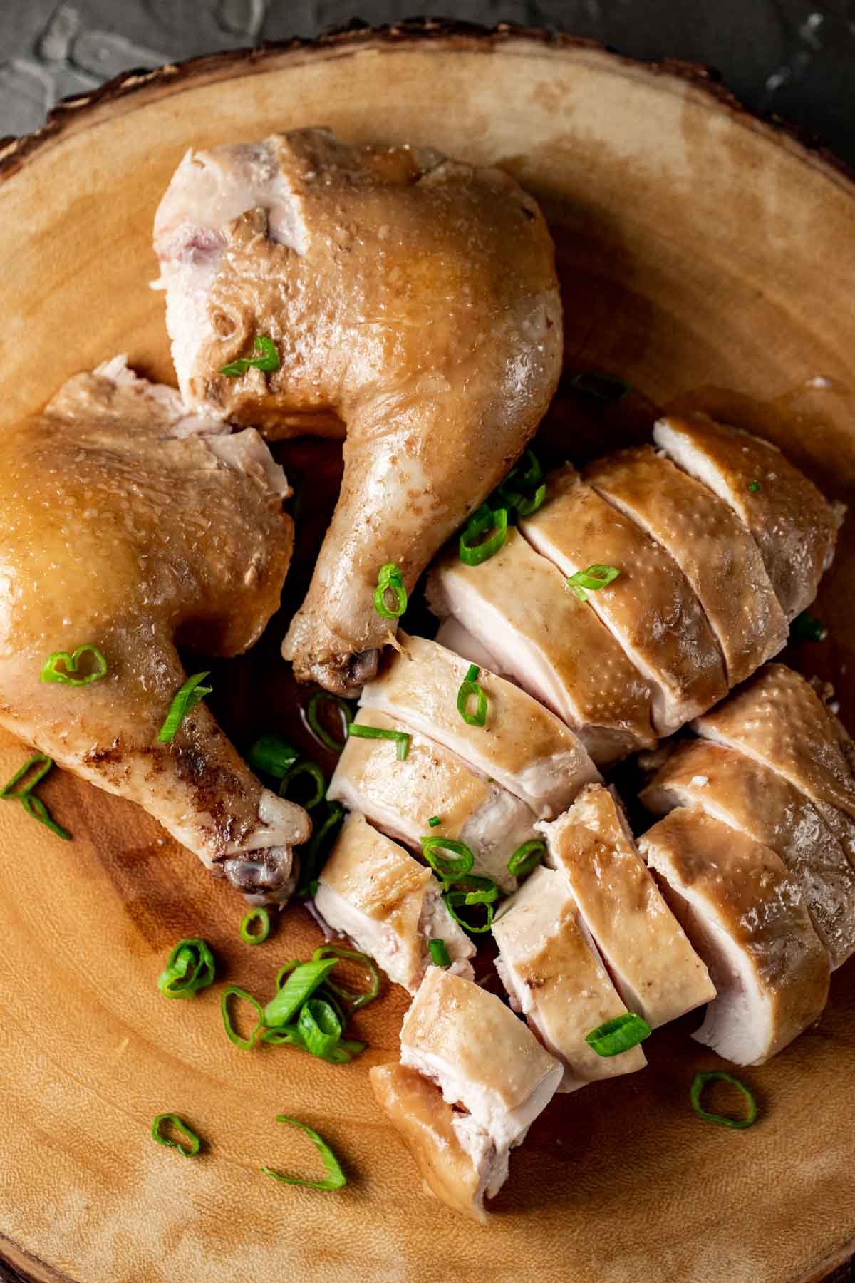 Soy sauce chicken cut into pieces and topped with green onions.