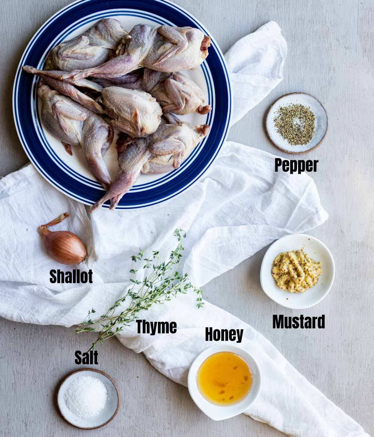 Ingredients to make sous vide quail arranged individually and labelled.