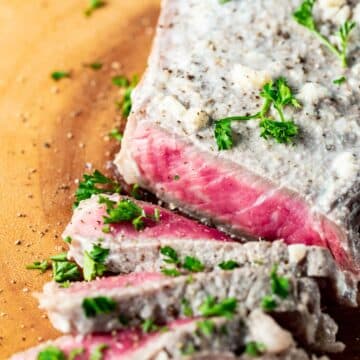 Close up view of medium rare slices of milk steak.