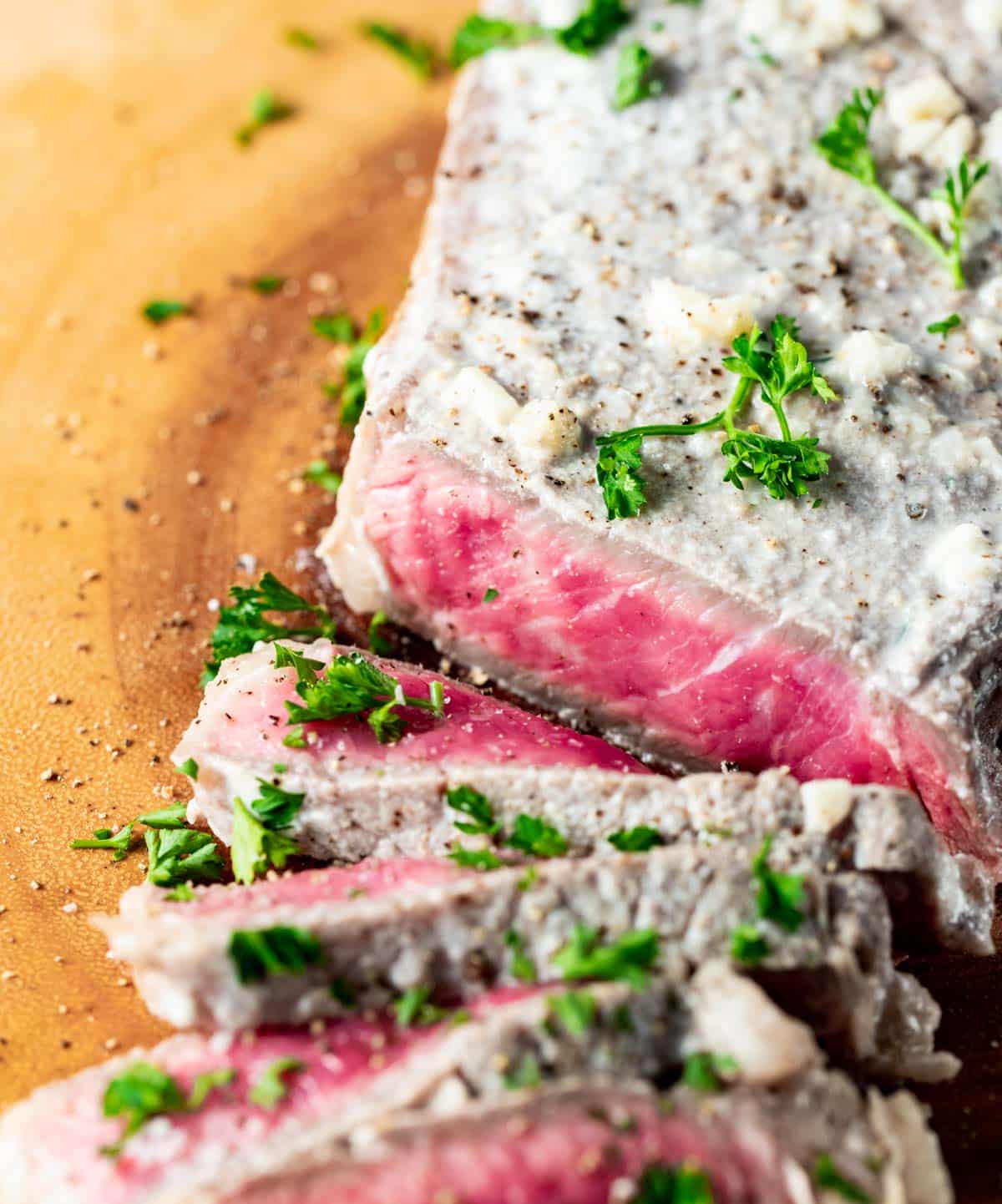 Close up view of medium rare slices of milk steak.