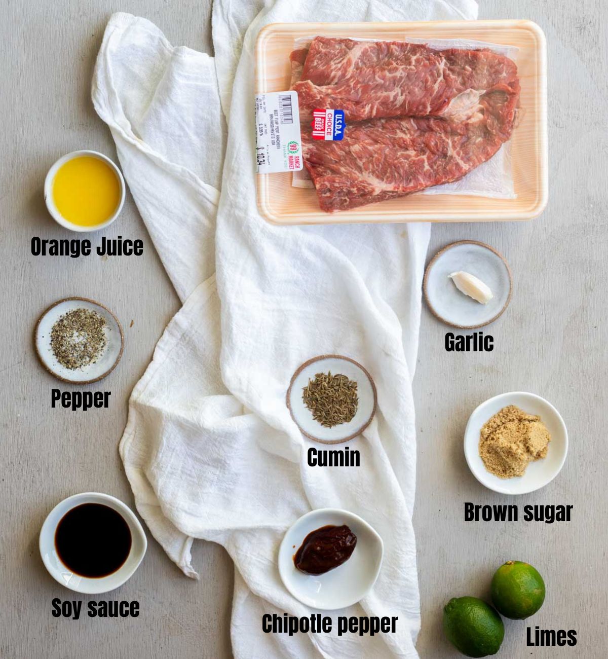 Ingredients to make Instant Pot carne asada arranged individually and labelled.