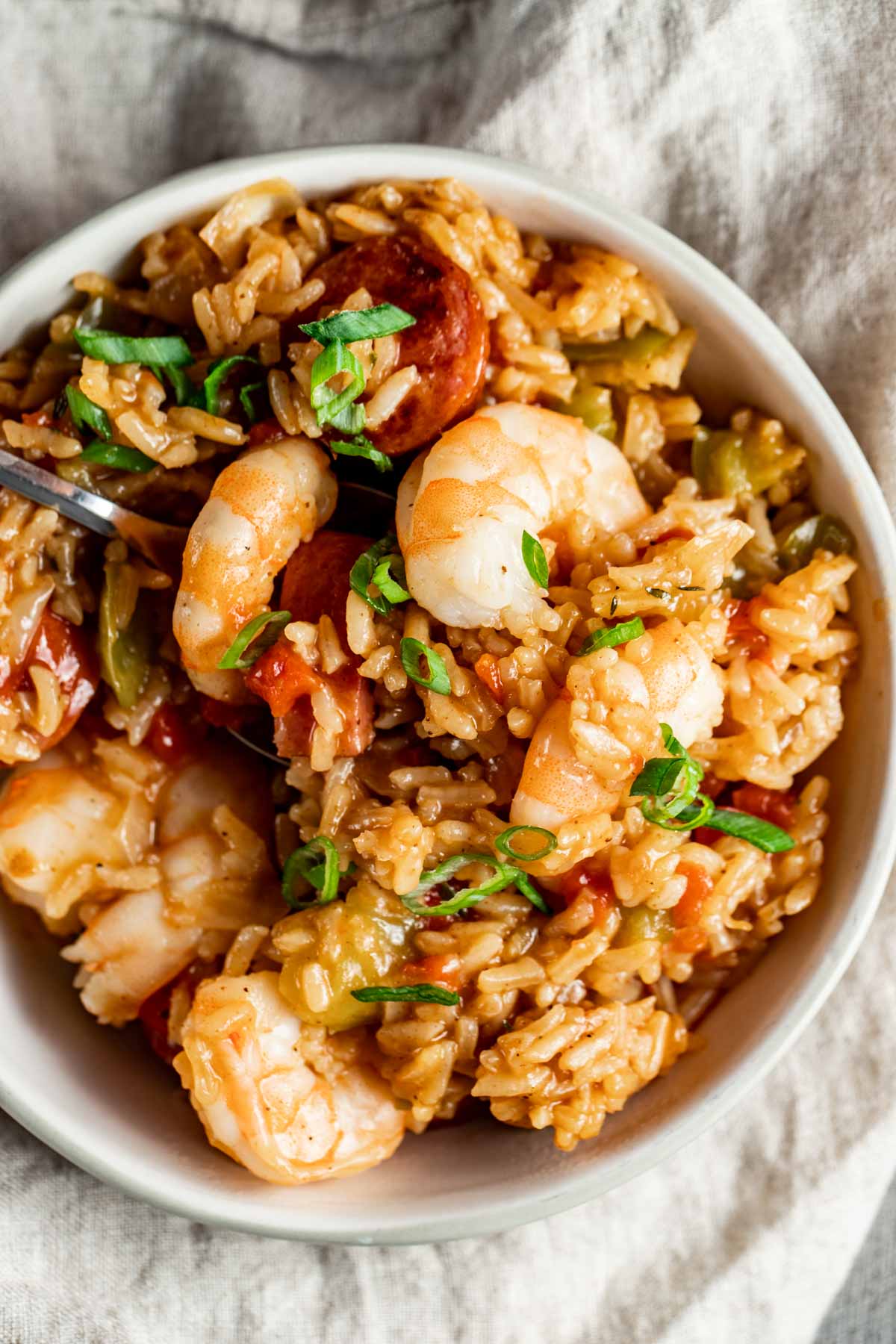 Jambalaya in a bowl, showcasing the plump shrimp, and topped with green onions.