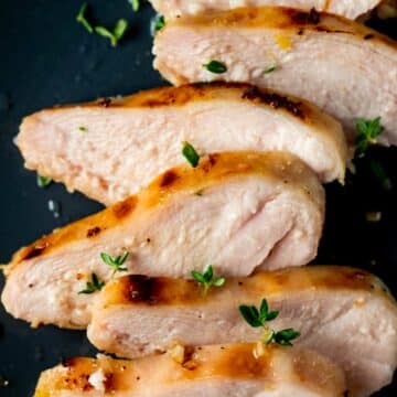 Close up view of sliced sous vide frozen chicken breast on a plate.