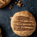 a pumpkin gingerbread cookie on a dark surface