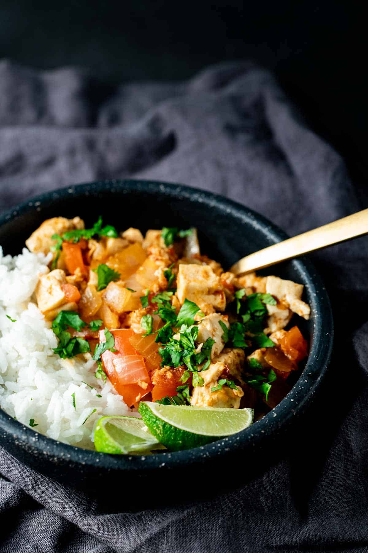 up close view of Sambal Tofu in a black bowl ready to serve