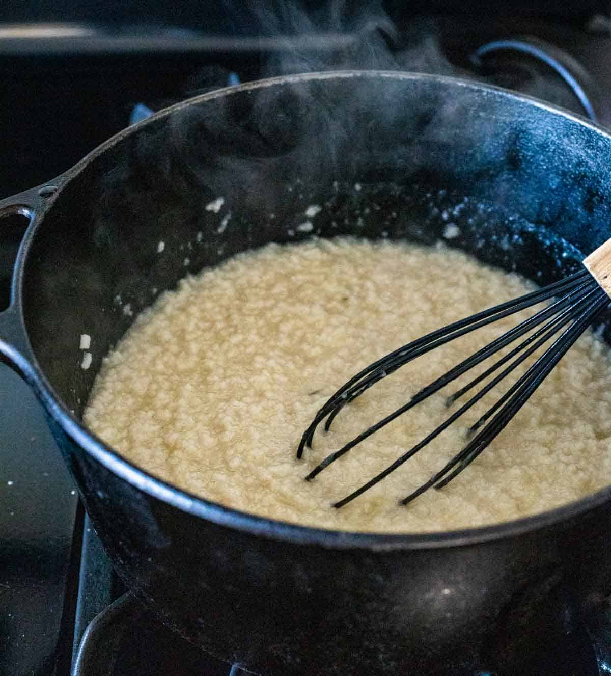porridge being stirred in a large pot