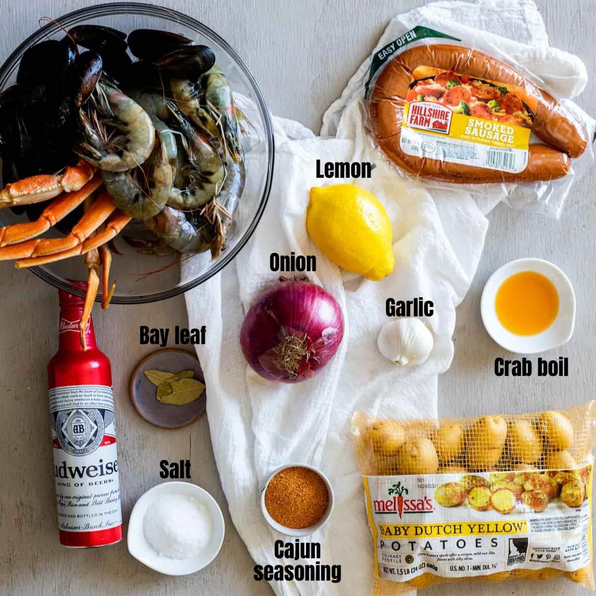 ingredients for cajun seafood boil in a gray board