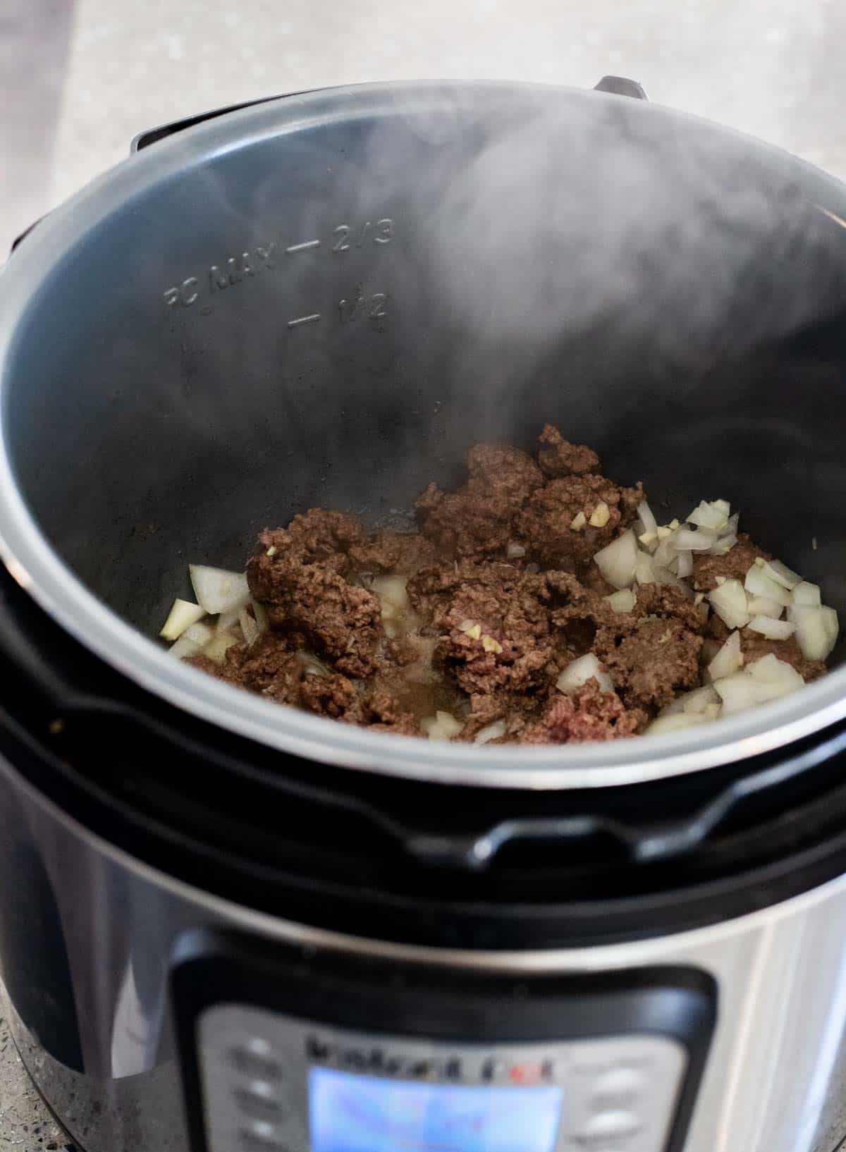ground beef cooking in an instant pot insert