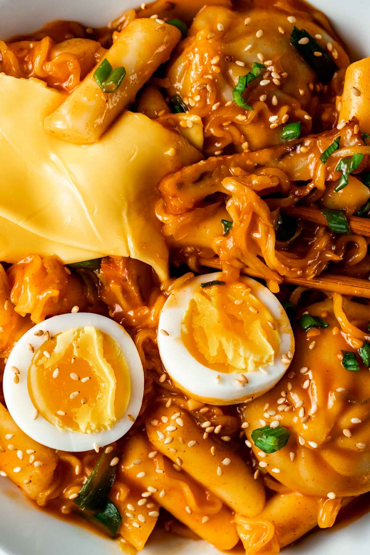 noodles in an orange sauce with American cheese on top