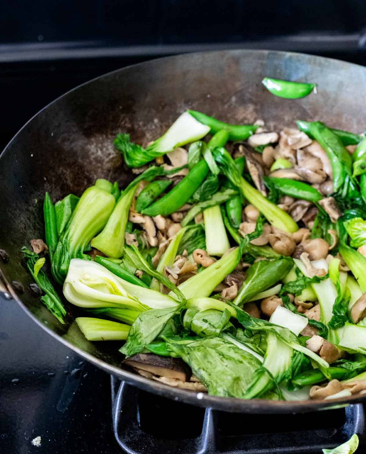 green vegetables cooking in a wok