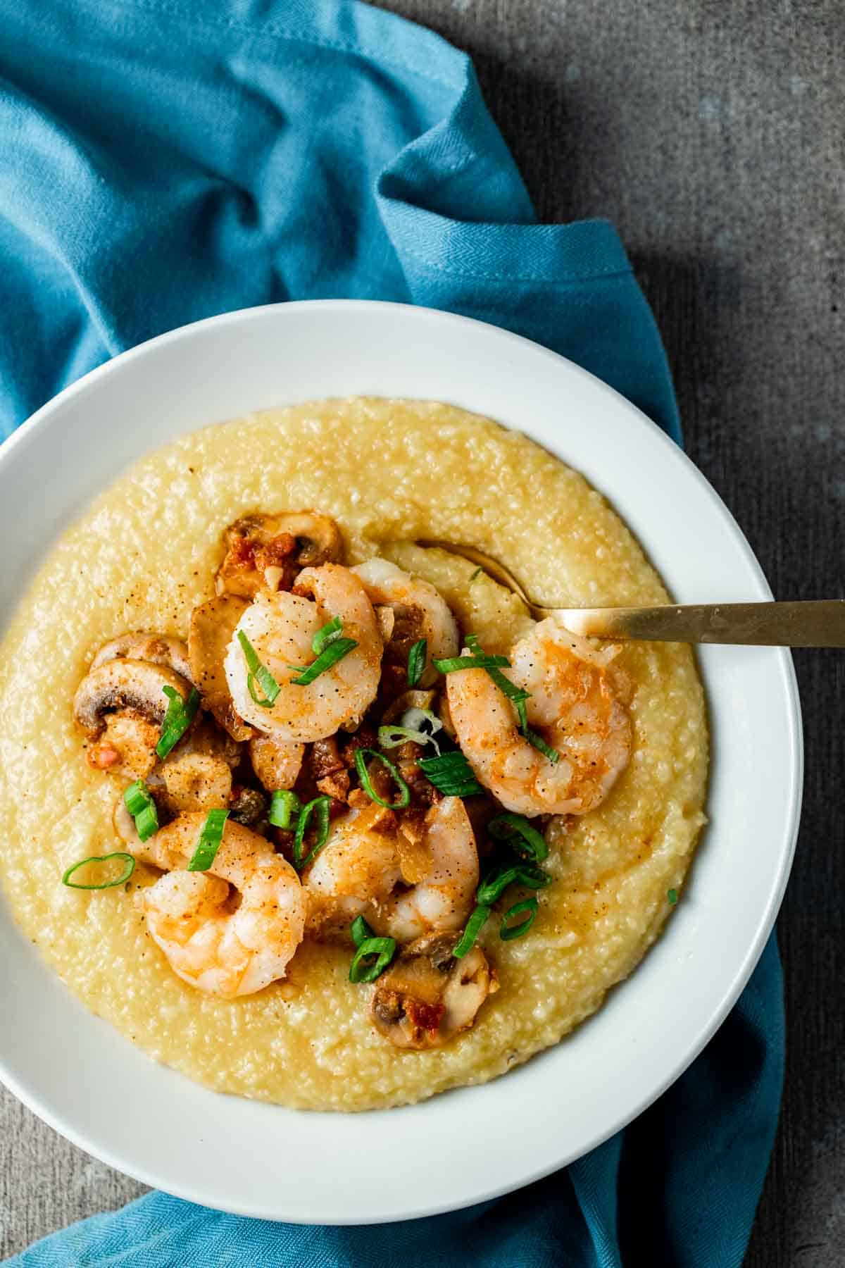 shrimp and grits topped with green onions in a white bowl