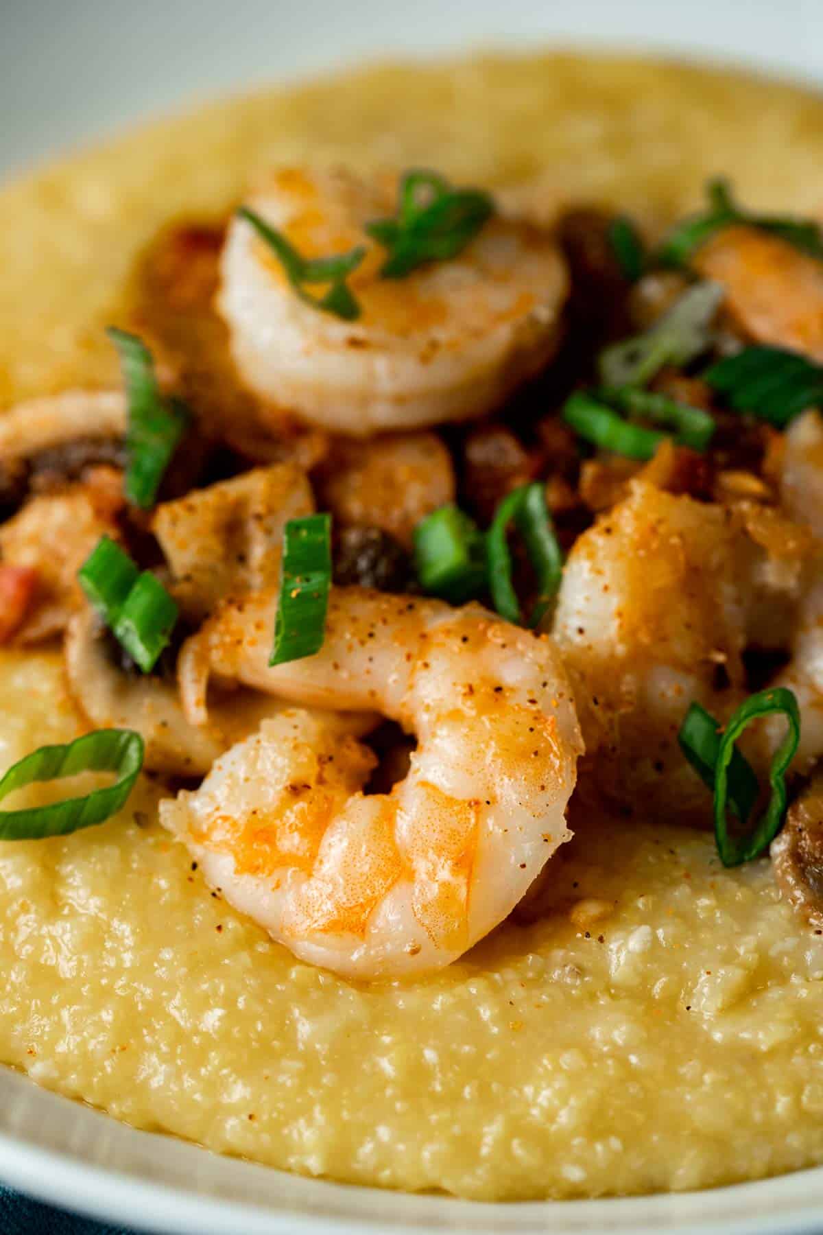 cooked shrimp in a pile over yellow grits