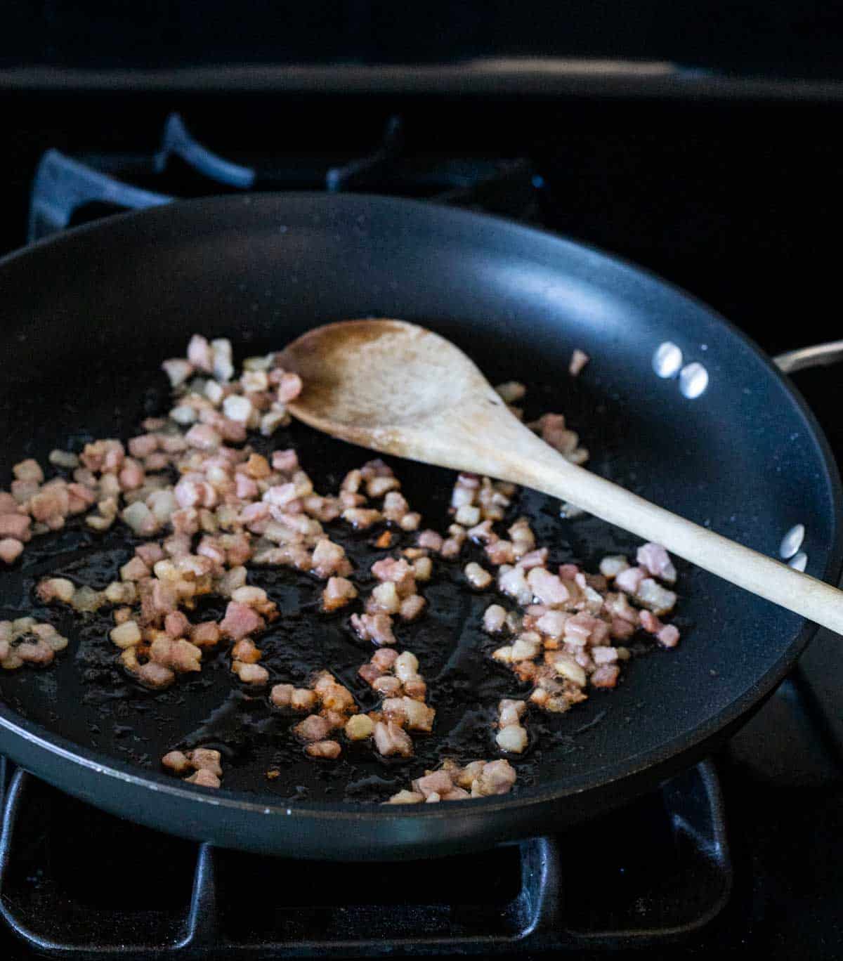 pancetta being browned in a skillet