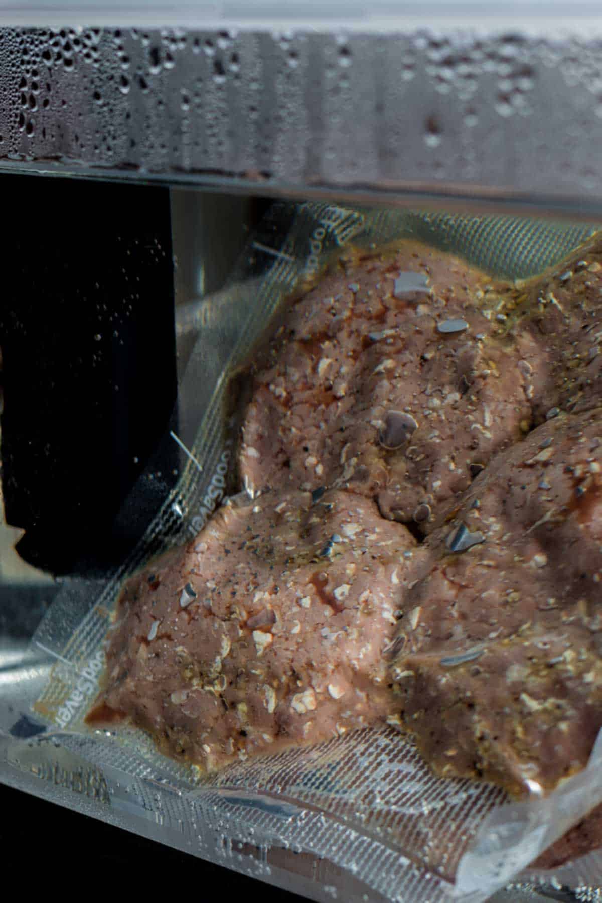 hamburgers being cooked in a sous vide water bath