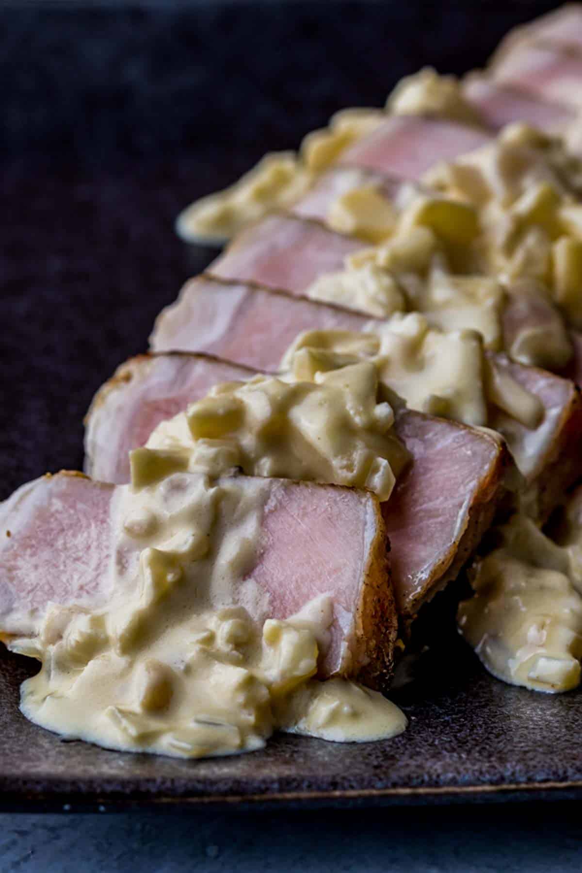 pork chops sliced and drizzled in a cream sauce