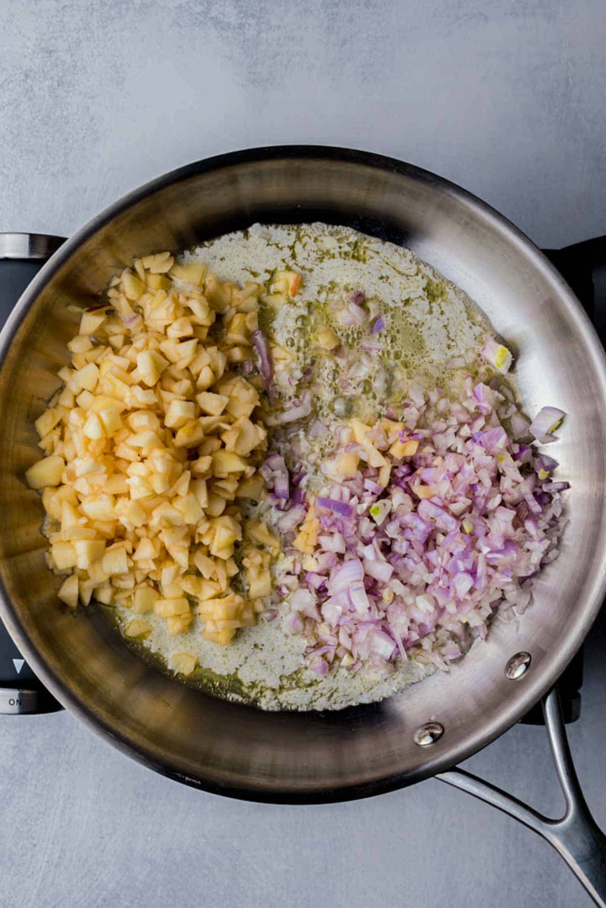 chopped apple, onions and sauce in a skillet