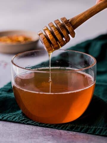 honey being drizzled into a bowl