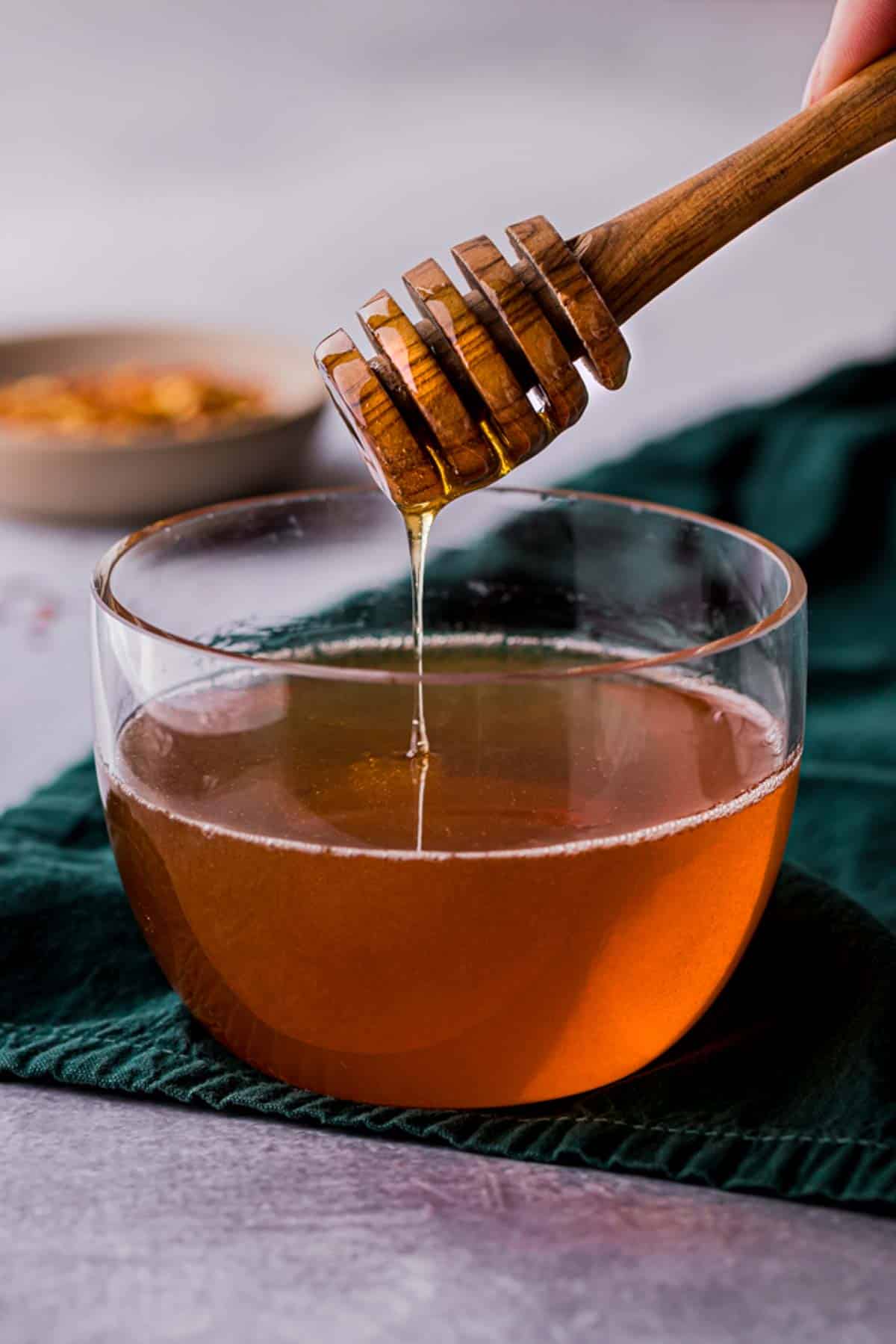 honey being drizzled into a bowl