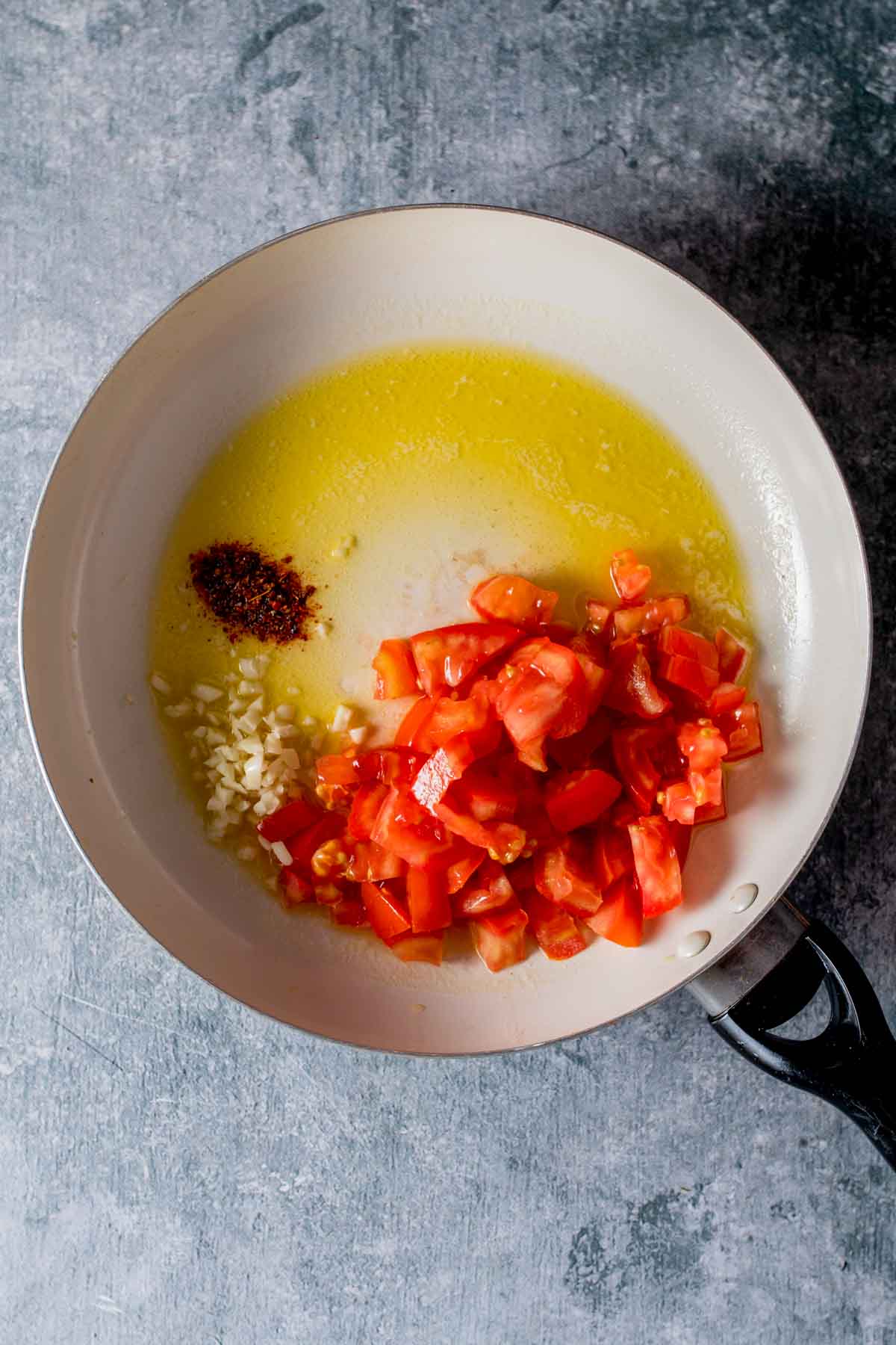 oil, garlic and tomatoes in a saute pan