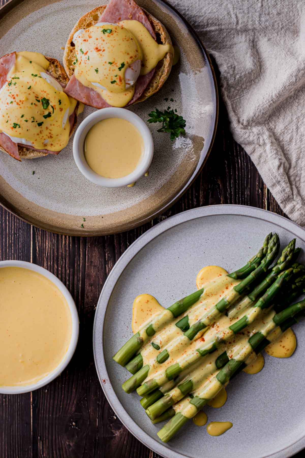a bowl of hollandaise with asparagus and eggs benny drizzled in it