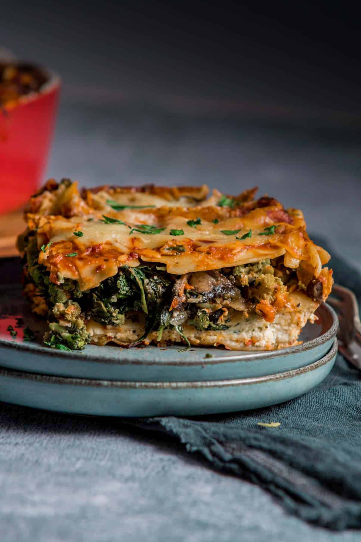 a piece of lasagna filled with spinach and mushrooms