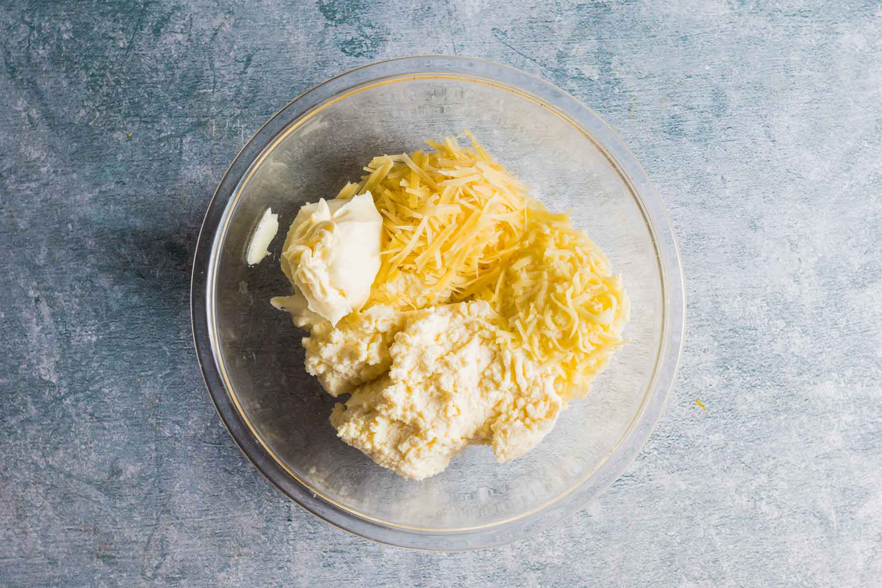 a bowl of shredded cheese and cottage cheese