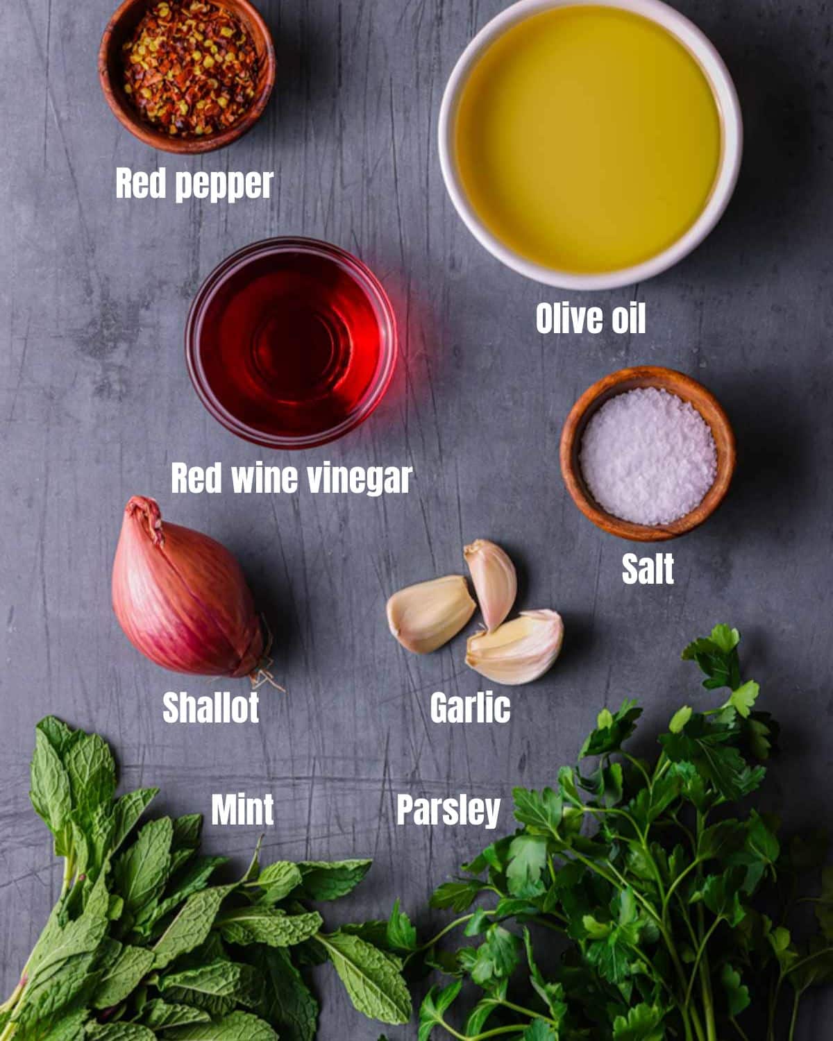 ingredients for mint chimichurri on a grey board
