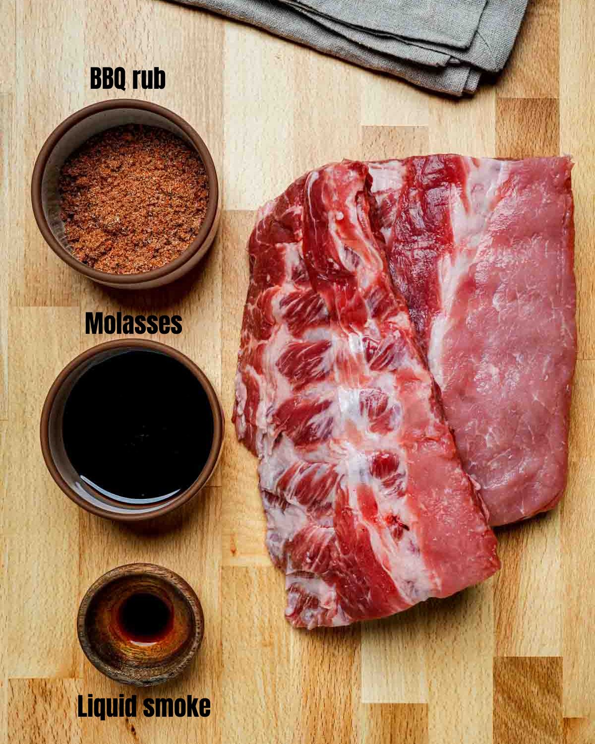 ingredients for sous vide pork ribs on a wood board