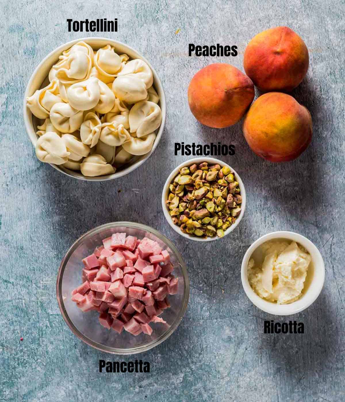 ingredients for summer tortellini salad on a board