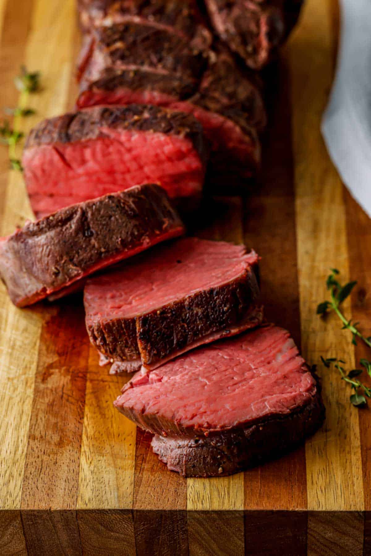 rare slices of beef on a cutting board
