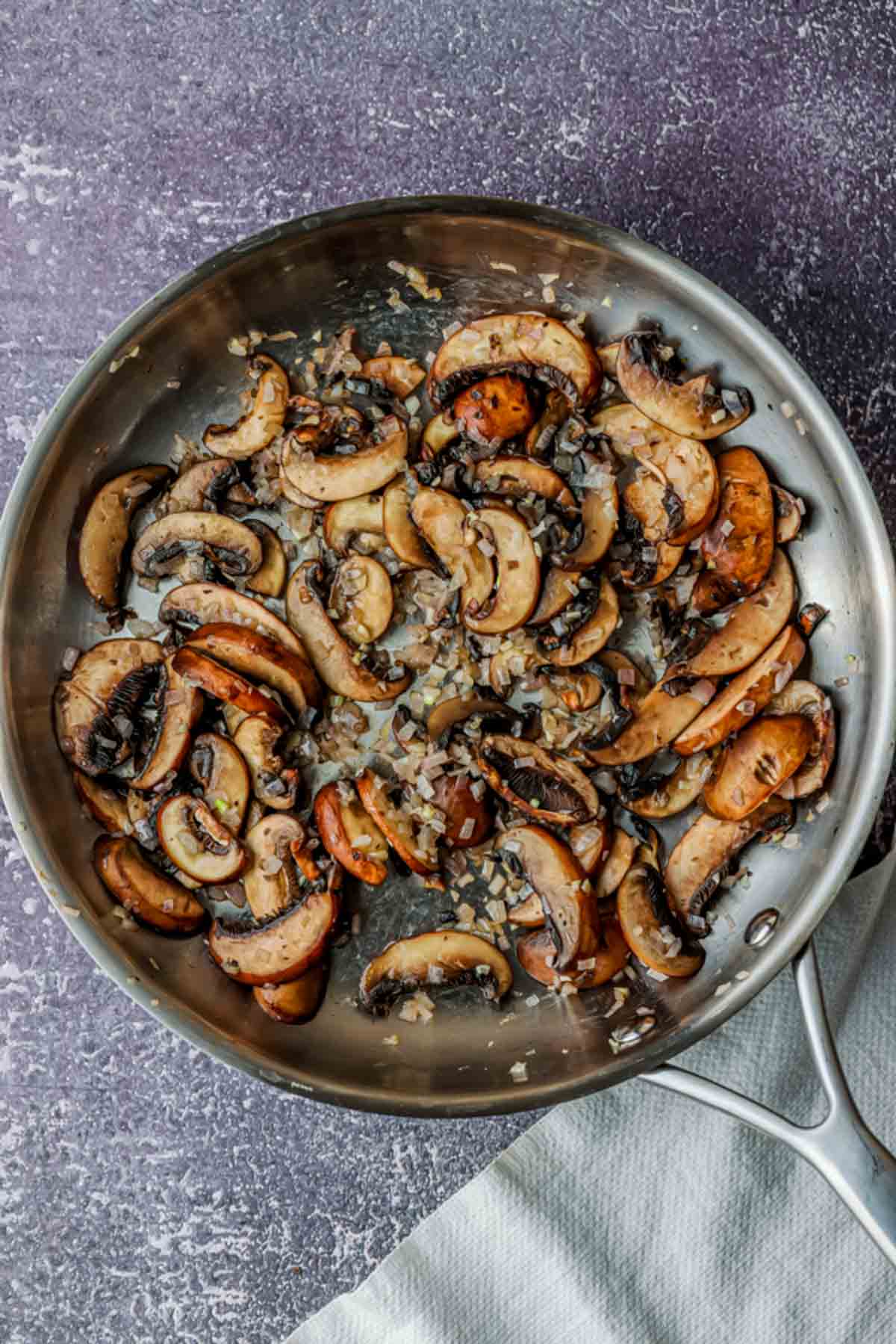 garlic and mushrooms cooking in a skillet