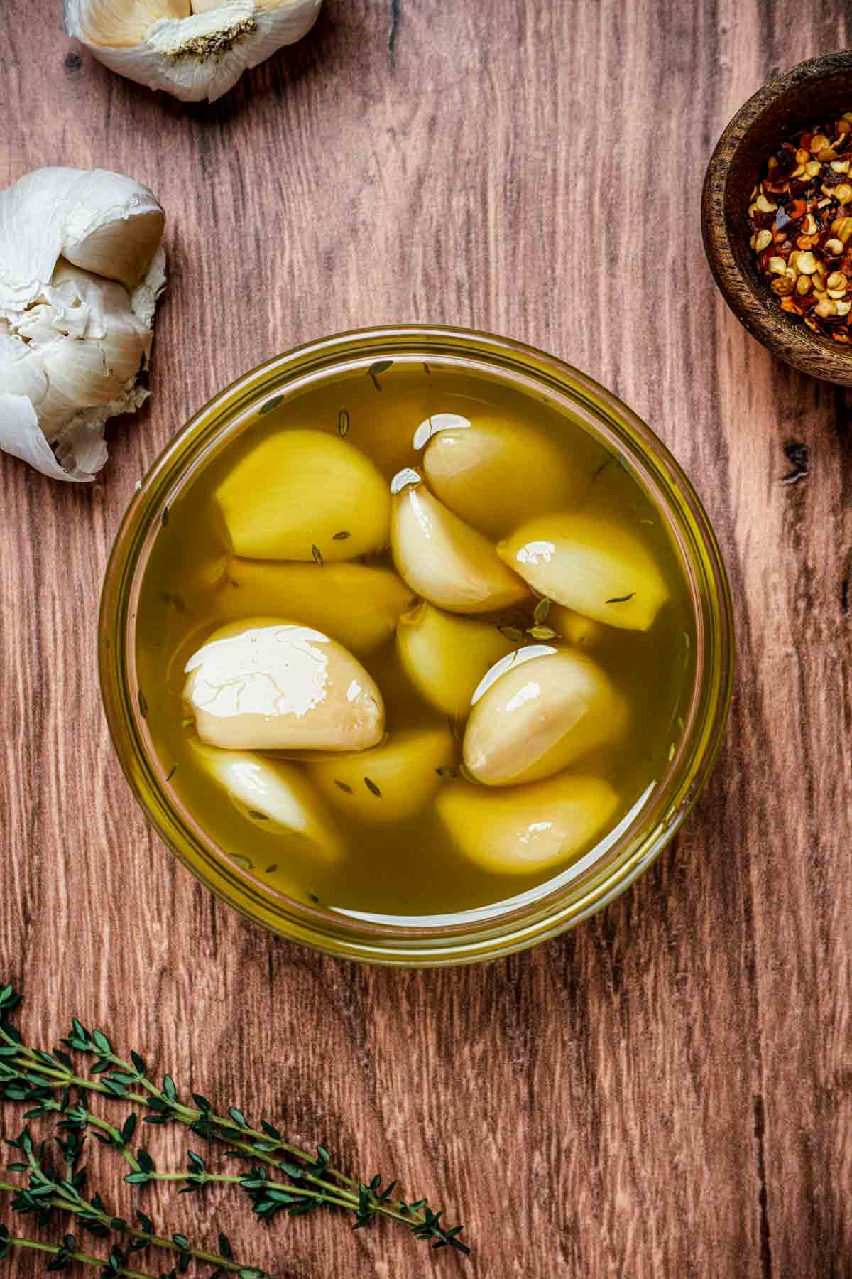 garlic cloves in a bowl of oil